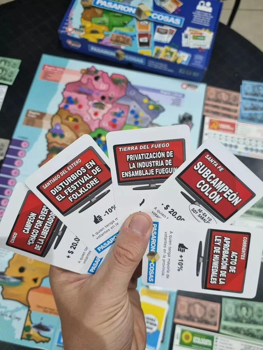 Hand holding game cards with text in a colorful game box background